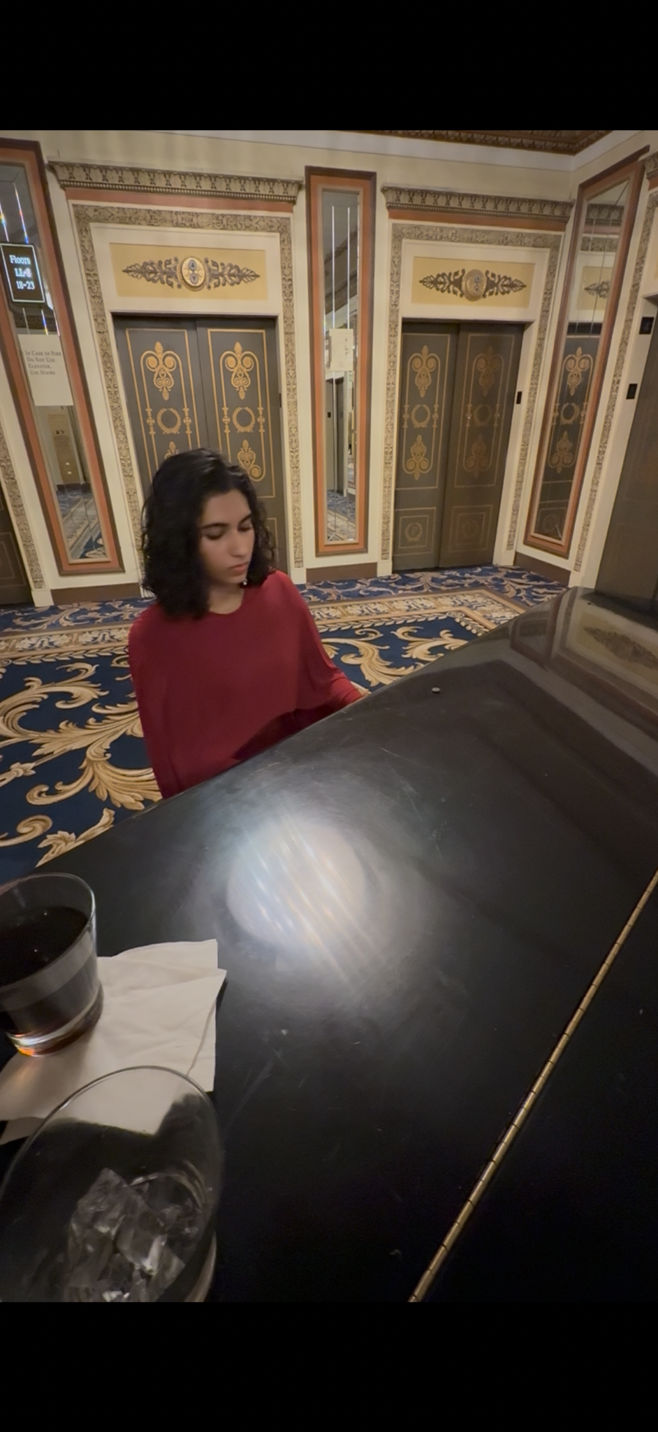 Sophia playing piano in an elegant indoor venue
